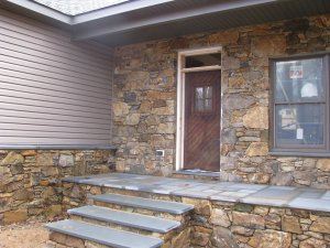 Front of home finished with real stone veneer from on-site